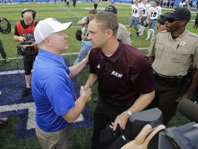 Kentucky head coach Mark Stoops, left, and Eastern Kentucky head coach Mark Elder greet each other after an NCAA college football game Saturday, Sept. 9, 2017, in Lexington, Ky. Kentucky won the game 27-16. (AP Photo/David Stephenson)