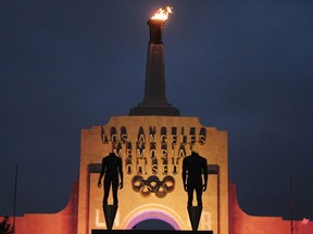 A blazing Olympic cauldron is seen at the Los Angeles Memorial Coliseum on Wednesday, Sept. 13, 2017. The cauldron was lit early Wednesday morning at the stadium that was the site of the 1932 and 1984 Olympics. An International Olympic Committee meeting in Peru is to make it official that LA will host in 2028 and that the 2024 Games will go to Paris. (AP Photo/Richard Vogel)
