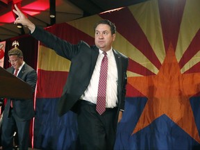 FILE - In this Nov. 4, 2014 file photo Arizona Republican Attorney General Mark Brnovich waves to supporters at the Republican election night party in Phoenix. Attorneys general in 20 Republican states are urging the U.S. Supreme Court to allow the release of videos made by an anti-abortion group whose leaders are facing felony charges in California for recording people without permission. The friend-of-the-court brief filed by Brnovich, on Thursday, Sept. 7, 2017, says the justices should lift an order from the 9th U.S. Circuit Court of Appeals barring the recordings' release. They were made by the Center for Medical Progress at meetings of an abortion provider association. (AP Photo/Ross D. Franklin, File)