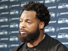 FILE - In this Sept. 24, 2017, file photo, Seattle Seahawks defensive end Michael Bennett speaks at a news conference after an NFL football game against the Tennessee Titans in Nashville, Tenn. Clark County Sheriff Joe Lombardo said Friday, Sept. 29,2017, that officers acted appropriately and professionally detaining Bennett after a report of gunfire at an after-hours club on the Las Vegas Strip.  (AP Photo/James Kenney, File)