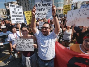 Protestors rally in support of the Deferred Action for Childhood Arrivals, or DACA, during a Labor Day rally in downtown Los Angeles on Monday, Sept. 4, 2017. President Donald Trump is expected to announce this week that he will end the Deferred Action for Childhood Arrivals, but with a six-month delay, according to two people familiar with the decision-making. (AP Photo/Richard Vogel)