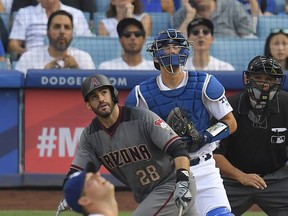 Arizona Diamondbacks' J.D. Martinez, second from left, runs to first as he hits a two-run home run as Los Angeles Dodgers starting pitcher Rich Hill, left, watches along with catcher Austin Barnes, second from right, and home plate umpire Alfonso Marquez run during the fourth inning of a baseball game, Monday, Sept. 4, 2017, in Los Angeles. (AP Photo/Mark J. Terrill)