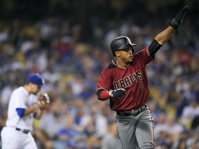 Arizona Diamondbacks' Ketel Marte, right, gestures toward second after scoring on a double by Adam Rosales as Los Angeles Dodgers relief pitcher Luis Avilan walks back to the mound during the seventh inning of a baseball game, Wednesday, Sept. 6, 2017, in Los Angeles. (AP Photo/Mark J. Terrill)