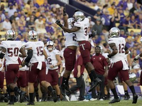 Troy linebacker A.J. Smiley (31) celebrates a defensive play on fourth down making LSU turnover on downs in the first half of an NCAA college football game in Baton Rouge, La., Saturday, Sept. 30, 2017. (AP Photo/Matthew Hinton)