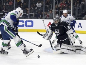 Vancouver Canucks center Markus Granlund (60) attacks as Los Angeles Kings goalie Jonathan Quick defends in the first period of an NHL preseason hockey game in Los Angeles Saturday, Sept. 16, 2017. (AP Photo/Reed Saxon)