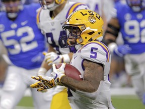 LSU running back Derrius Guice (5) runs against BYU in the first half of an NCAA college football game in New Orleans, Saturday, Sept. 2, 2017. (AP Photo/Scott Threlkeld)