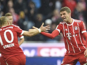 Munich's Thomas Mueller, right, and Arjen Robben celebrate their sides first goal during the first division Bundesliga soccer match between Bayern Munich and FSV Mainz 05 in Munich, Germany, Saturday, Sept. 16, 2017. (Andreas Gebert/dpa via AP)