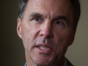 Finance Minister Bill Morneau responds to questions from reporters during a Liberal caucus retreat in Kelowna, B.C., on Wednesday September 6, 2017