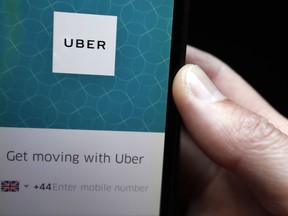 An Uber App is displayed on a phone in London, Friday, Sept. 22, 2017. London's transport authority said Friday it won't renew Uber's license to operate in the British capital, arguing that it demonstrates a lack of corporate responsibility with implications in public safety and security. (AP Photo/Kirsty Wigglesworth)