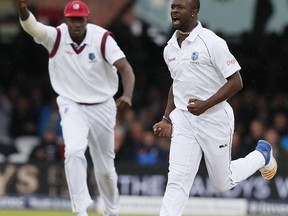 West Indies' Kemar Roach celebrates taking the wicket of England's Dawid Malan on the second day of the third test match between England and the West Indies at Lord's cricket ground in London, Friday, Sept. 8, 2017. (AP Photo/Kirsty Wigglesworth)