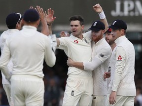 England's James Anderson, centre, celebrates taking the wicket of West Indies' Jermaine Blackwood on the third day of the third test match between England and the West Indies at Lord's cricket ground in London, Saturday, Sept. 9, 2017. (AP Photo/Kirsty Wigglesworth)