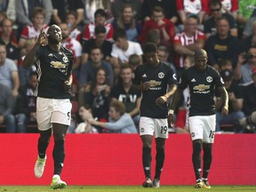 Manchester United's Romelu Lukaku, left, celebrates scoring his side's first goal of the game during their English Premier League soccer match against Southampton at St Mary's Stadium, Southampton, England, Saturday, Sept. 23, 2017. (Andrew Matthews/PA via AP)