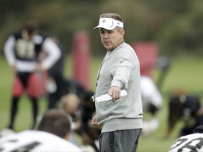 New Orleans Saints head coach Sean Payton supervises the stretching session of an NFL training session at the London Irish rugby team training ground in the Sunbury-on-Thames suburb of south west London, Friday, Sept. 29, 2017. The New Orleans Saints are preparing for an NFL regular season game against the Miami Dolphins at London's Wembley stadium on Sunday. (AP Photo/Matt Dunham)