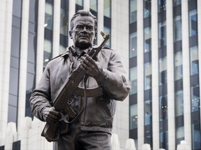 FILE  - In this Tuesday, Sept. 19, 2017 file photo, a new monument of Russian firearm designer Mikhail Kalashnikov is unveiled during an official ceremony in Moscow, Russia. Just days after a monument honoring AK-47 designer Mikhail Kalashnikov was unveiled in Moscow, workers have removed a part of it that showed a German weapon that many believe inspired the renowned assault rifle. (AP Photo/Pavel Golovkin, File)