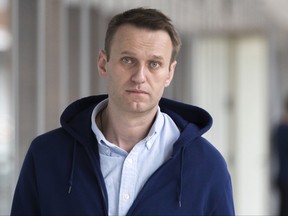 FILE - In this Friday, July 7, 2017 file photo, Russian opposition leader Alexei Navalny arrives at his office in Moscow, Russia. Police on Friday Sept. 29, 2017 detained Russian opposition leader Alexei Navalny ahead of a rally he was planning to lead in Nizhny Novgorod. (AP Photo/Pavel Golovkin, File)