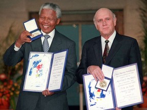 FILE - In this Dec. 10, 1993 file photo, South African Deputy President F.W. de Klerk, right, and South African President Nelson Mandela pose with their Nobel Peace Prize Gold Medals and Diplomas in Oslo. The Nobel Committee praised the pair "for their work for the peaceful termination of the apartheid regime, and for laying the foundations for a new democratic South Africa." This year's winner is set to be announced on Friday, Oct. 6, 2017. (AP Photo/File)