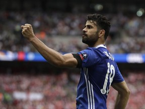 CAPTION CORRECTS THE DATE - FILE - In this Saturday, May 27, 2017 file photo, Chelsea's Diego Costa celebrates scoring his team's equalizer during their English FA Cup final soccer match against Arsenal at the Wembley stadium in London. Atletico Madrid and Chelsea on Thursday, Sept. 21 say they have reached an agreement for the transfer of striker Diego Costa to the Spanish club. Chelsea says it gave Costa permission to travel to Madrid to undergo a medical and finalize the contract details with his former club. (AP Photo/Matt Dunham, file)