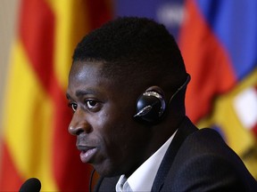 FILE - In this Monday, Aug. 28, 2017 file photo, Barcelona's new signing player Ousmane Dembele speaks during a press conference of his official presentation at the Camp Nou stadium in Barcelona, Spain. Dembele, the 20-year-old France striker signed by Barcelona to replace Neymar is expected to make his debut in the Catalan derby against Espanyol on Saturday, Sept. 9, 2017. (AP Photo/Manu Fernandez, File)