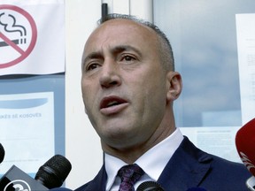 FILE - In this file photo dated Sunday, June 11, 2017, Ramush Haradinaj, candidate for Prime Minister, speaks to media reporters after casting his ballot during the early parliamentary elections Pristina, Kosovo.  The ex-prime minister of Kosovo and former guerrilla fighter, Haradinaj was nominated Thursday Sept. 7, 2017, as the country's new premier and tasked with creating a new Cabinet.(AP Photo/Visar Kryeziu, FILE)
