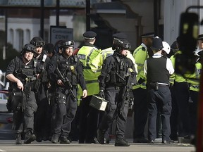 Armed police close to Parsons Green station in west London after an explosion on a packed London Underground train, Friday, Sept. 15, 2017. (Dominic Lipinski/PA via AP)