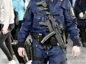 This is a April 13, 2017  file photo of a Finnish police officer carrying a MP5 submachine gun patrols at the Helsinki-Vantaa airport in Vantaa Finland.