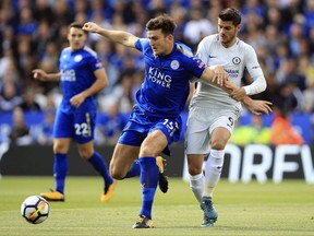 Leicester City's Harry Maguire, left, and Chelsea's Alvaro Morata battle for the ball during the English Premier League soccer match at the King Power Stadium, Leicester, England, Saturday Sept. 9, 2017. (Mike Egerton/PA  via AP)