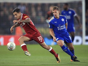 Liverpool's Philippe Coutinho, left, and Leicester City's Marc Albrighton battle for the ball during their English League Cup, third round soccer match at the King Power Stadium, Leicester, England, Tuesday, Sept. 19, 2017. (Mike Egerton/PA via AP)