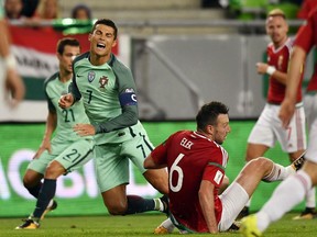 Hungary;s Akos Elek right, collides with Portugal's Cristiano Ronaldo, during the World Cup Group B first round soccer match between Hungary and Portugal, at the Groupama Arena, in Budapest, Hungary, Sunday, Sept. 3, 2017. (Tibor Illyes/MTI via AP)