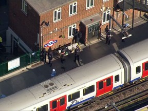 In this aerial image made from video, police officers work at the Parsons Green Underground Station after an explosion in London Friday, Sept. 15, 2017. A reported explosion at a train station sent commuters stampeding in panic, injuring several people at the height of London's morning rush hour, and police said they were investigating it as a terrorist attack. (Pool via AP)