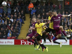 Manchester City's Sergio Aguero, right, scores his side's first goal of the game against Watford during their English Premier League soccer match at Vicarage Road in Watford, England, Saturday Sept. 16, 2017. (Nigel French/PA via AP)