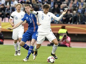 Finland's Perparim Hetemaj, right, battles for the ball with Iceland's Birkir Saevarsson during their World Cup Group I qualifying soccer match in Tampere, Finland, Saturday, Sept. 2, 2017. (Jussi Nukari/Lehtikuva via AP)