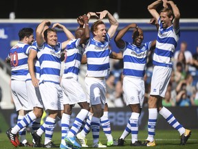 Team Ferdinand, from left,  captain - singer Marcus Mumford, presenter Ben Shephard, athlete Mo Farah, actor Damian Lewis, DJ Spoony and soccer player Peter Crouch celebrate after Farah scores the first goal of the match  first goal of the match during Game4Grenfell, a charity football match to raise funds for Grenfell Tower survivors at QPR's Loftus Road stadium in London, Saturday, Sept. 2, 2017. Stars from the entertainment and sports worlds have played a soccer match in London to benefit victims of the Grenfell Tower fire that claimed more than 80 lives in June.  (Victoria Jones/PA via AP)