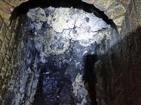 In this undated handout photo issued by Thames Water on Tuesday, Sept. 12, 2017, a view of a fatberg inside a sewer in Whitechapel, London. British engineers say they have launched a "sewer war" against a giant fat blob clogging London's sewers. Thames Water officials said Tuesday it is likely to take three weeks to dissolve the outsize fatberg. (Thames Water via AP)