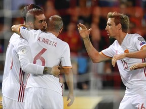 Players of Spain react after Sergio Ramos, second from left, scored the first goal of the game during the 2018 Fifa World Cup Russia group G qualification soccer match between Liechtenstein and Spain at the Rheinpark stadium in Vaduz, Liechtenstein, on Tuesday, Sept.5, 2017. (Gian Ehrenzeller/Keystone via AP)