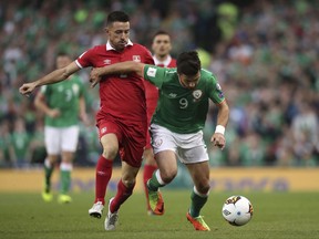 Republic of Ireland's Shane Long, right, and Serbia's Antonio Rukavina in action during the 2018 FIFA World Cup Qualifying, Group D match at the Aviva Stadium in Dublin, Ireland, Tuesday Sept. 5, 2017. (Niall Carson/PA via AP)