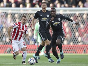 Stoke City's Xherdan Shaqiri and Manchester United's Paul Pogba, right, battle for the ball during the English Premier League soccer match at the bet365 Stadium, Stoke, England, Saturday, Sept. 9, 2017. (Nick Potts/PA via AP)