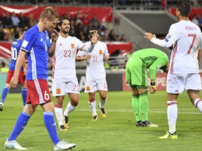 Spain's Isco, centre left, and Alvaro Morata, right, react after scoring to take teh score to 0-3, with Liechtenstein's goalkeeper Peter Jehle, 2nd right, during the 2018 Fifa World Cup Russia group G qualification soccer match between Liechtenstein and Spain at the Rheinpark stadium in Vaduz, Liechtenstein, on Tuesday, Sept. 5, 2017. (Gian Ehrenzeller/Keystone via AP)