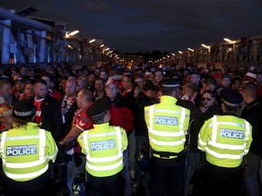 FC Koln fans and police outside the stadium prior to the Europa League match against Arsenal at the Emirates Stadium, London, Thursday Sept. 14, 2017. Extra police have been sent to the stadium to deal with disorder after thousands of Cologne fans turned up ahead of a match. The game was due to kick off at 8.05pm but has been delayed by an hour in the interest of fan safety after huge crowds of Cologne supporters arrived at the ground. (Nick Potts/PA via AP)