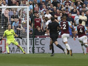 Tottenham's Harry Kane, second left, scores his team's first goal during the English Premier League soccer match between West Ham United and Tottenham Hotspur at the London Stadium in London, Saturday Sept. 23, 2017. (AP Photo/Tim Ireland)