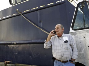FILE - In this Oct. 14, 2014, file photo, Carlos Rafael talks on the phone at Homer's Wharf near his herring boat F/V Voyager in New Bedford, Mass. The U.S. fishing magnate known as "The Codfather" who pleaded guilty to evading fishing quotas and smuggling money to Portugal is set to be sentenced begining in Boston's federal court on Monday, Sept. 25, 2017. (John Sladewski/Standard Times via AP, File)