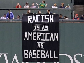 A banner is unfurled over the left field wall during the fourth inning of a baseball game between the Boston Red Sox and Oakland Athletics at Fenway Park in Boston, Wednesday, Sept. 13, 2017.