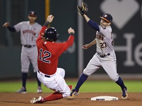 Houston Astros second baseman Jose Altuve (27) catches the throw as he sets to tag out Boston Red Sox's Brock Holt on an attempted to steal second during the eighth inning of a baseball game at Fenway Park in Boston, Friday, Sept. 29, 2017. The Red Sox challenged the play, but the original call was upheld. (AP Photo/Charles Krupa)