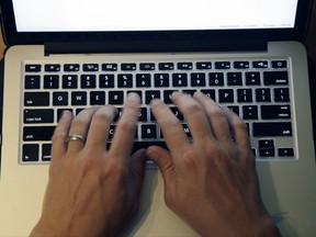 This Monday, June 19, 2017, photo shows fingers on laptop keyboard in North Andover, Mass. The Equifax breach not only exposed sensitive personal information of 143 million Americans, but it also underscored the huge and largely unaddressed vulnerabilities that make widespread identity theft possible. Experts have warned for years that the widespread use of Social Security numbers, lax corporate security and even looser individual password practices could lead to an identity-theft apocalypse. (AP Photo/Elise Amendola)