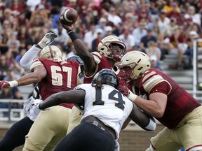 Boston College quarterback Anthony Brown (13) passes under pressure during the first half of an NCAA college football game against Wake Forest, Saturday, Sept. 9, 2017, in Boston. (AP Photo/Mary Schwalm)