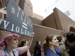 Alyssa Krupczak, left, of Somerville, Mass., protests Thursday, Sept. 21, 2017, with others outside the federal courthouse in Boston where U.S. Attorney General Jeff Sessions was speaking to law enforcement officials about transnational organized crime. Federal authorities last year charged more than 50 members of the transnational MS-13 gang in and around Boston with racketeering, drug trafficking and gun charges. (AP Photo/Steven Senne)