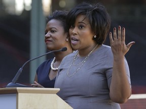 Tanisha Sullivan, NAACP Boston branch president, right, addresses an audience as Mass. state Sen. Linda Dorcena Forry, D-Boston, left, looks on during a panel discussion held to introduce an initiative called "Take The Lead," Thursday, Sept. 28, 2017, at Fenway Park in Boston. The Red Sox, Patriots, Celtics, Bruins, and Revolution are joining a project they're calling "Take the Lead" that was unveiled Thursday. (AP Photo/Steven Senne)