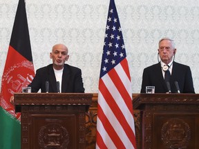 Afghan President Ashraf Ghani speaks next to U.S. Secretary of State Jim Mattis during a press conference at the Presidential Palace in Kabul on Sept. 27, 2017.