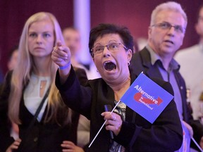 Guests at an Alternative for Germany party, AfD,  election party react to the first projections in the German election on Sunday, Sept. 24, 2017.