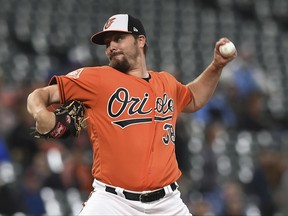 Baltimore Orioles pitcher Wade Miley throws against the Toronto Blue Jays' in the first inning of a baseball game, Saturday, Sept. 2, 2017, in Baltimore. (AP Photo/Gail Burton)