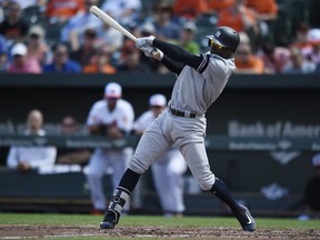 New York Yankees' Didi Gregorius follows through on a single against the Baltimore Orioles in the third inning of a baseball game, Thursday, Sept. 7, 2017, in Baltimore. (AP Photo/Gail Burton)